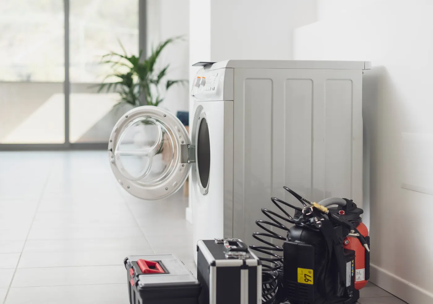 Washing machine with repair tools ready for a drain repair